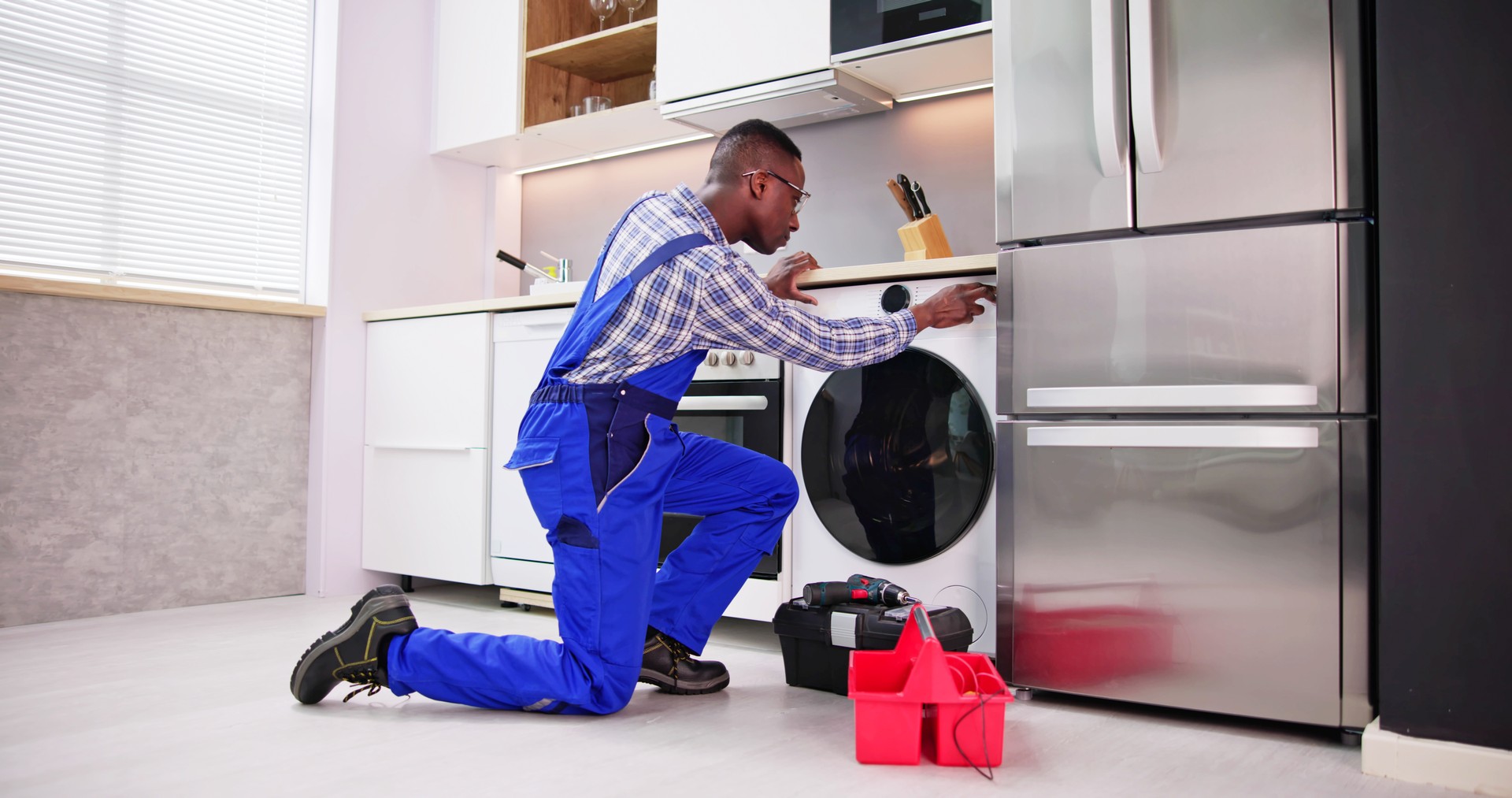 Young Man In Overall Repairing Washing